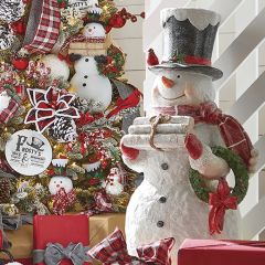 Snowman Statue Holding Birch Logs