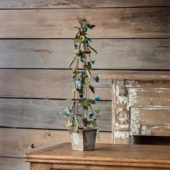 Potted Blue Metal Flowers On Trellis